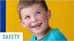 boy holding ball above head